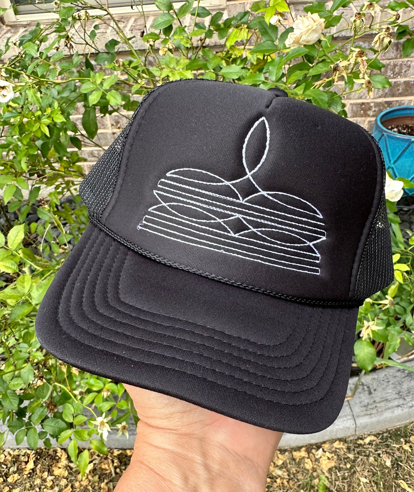 White Booth Stitch Embroidered Black Trucker Hat