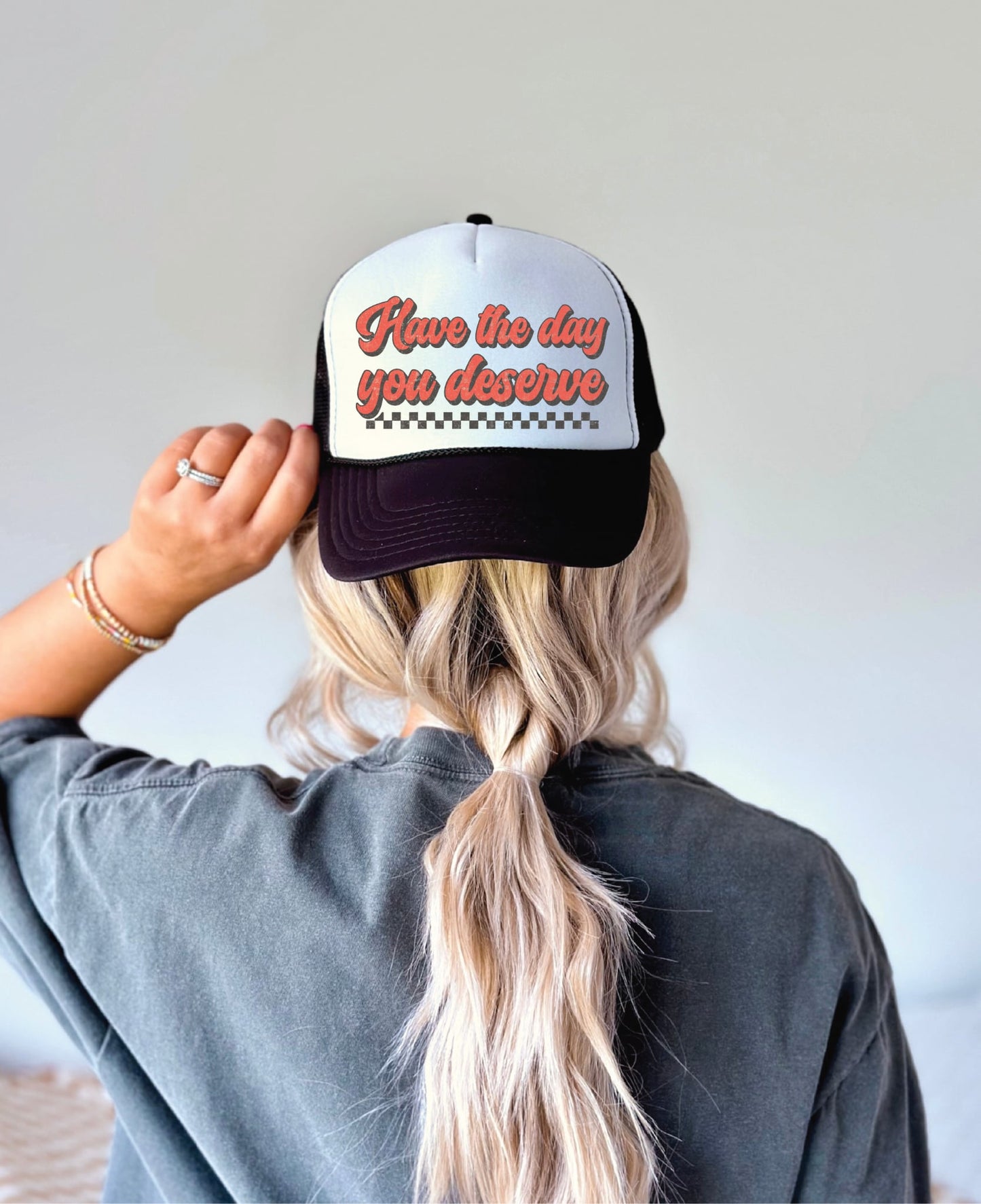 Have the Day You Deserve- Black & White Unisex Trucker Hat