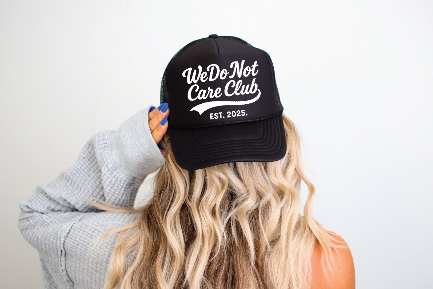 WE DO NOT CARE CLUB - UNISEX TRUCKER HAT