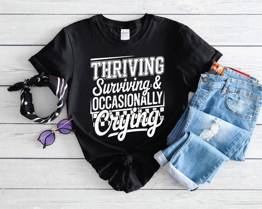Thriving, Surviving,Occasionally Crying-Black Comfort Color Unisex Graphic Tee